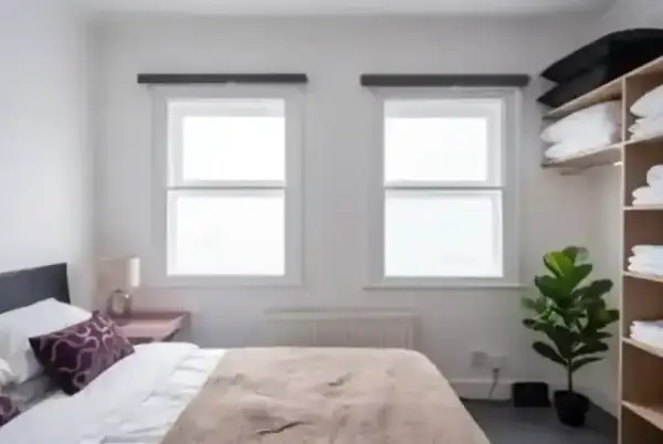 Bespoke secondary glazing installed in a bedroom, featuring slimline profiles that preserve the property's character.